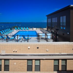 Rooftop Community Pool with Blue Lawn Chairs